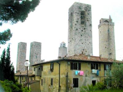 Towers: San Gimignano called, Town of Beautiful Towers. Overall skyline shows 13 towers.