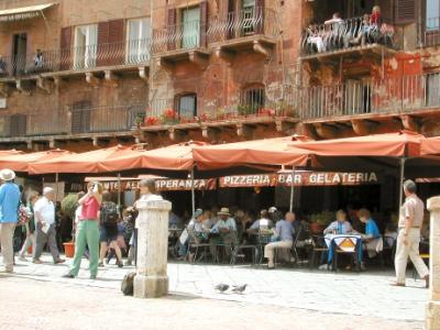 Judy leaning on a post on Piazza del Campo: We had drinks at the cafe behind her - great place for people watching.
