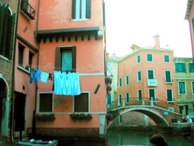 A canal as seen from the water taxi taking us to Marco Polo Airport. We saw laundry hung outdoors throughout Italy.