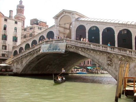 The Rialto Bridge over the Grand Canal. The bridge was built in the late 1500s. It is lined with shops.