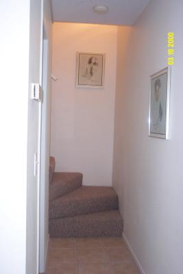  Hallway leading upstairs. The second level has new flooring with carpeted bedroom and stairway, tiled bath.jpg