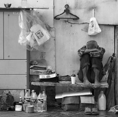 Street sweeper at his streetside quarters, Singapore