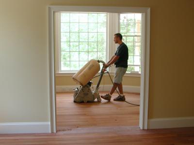 The floor finisher makes his first sanding pass through the library