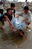 Indonesian kids carry bottles of drinking water