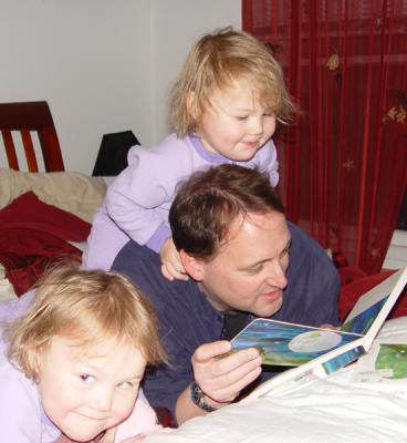 They switched places.  Reagan is getting a horsey ride while enjoying her nighttime story.