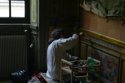 An artisan restoring the gold-leaf woodwork