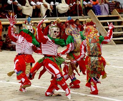 Dance of the Cremation Grounds,  an important thread in Tibetan Buddhist Wisdom, teaching impermanence in all aspects of life, including the mind, 5 skulls on top of the mask, rainbow colored fans on their ears. The actors are also called citti patti or tur tu tak ba.