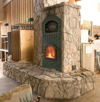 Stone hearth incorporates local fossils and animal footprints on ceramic tiles.