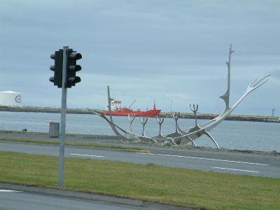 Viking ship statue with a modern ship