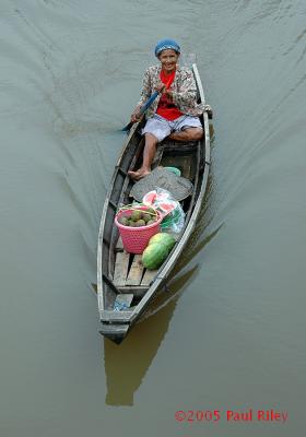 Lady selling fruit from a canoe - Palembang, Sumatra