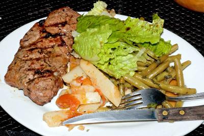 strip steak, greek potatoes, garlic mint beans, salad