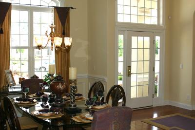 View of the dining room and front hallway from the hallway leading to the kitchen.