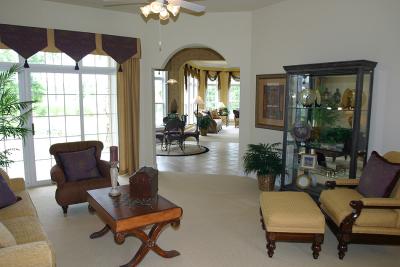 Formal living room. The curio cabinet space will contain a fireplace that will also be available from the kitchen (see through). The windows to the left face the rear patio. The floorplan veers to the right at a 45 degree angle, cutting through the breakfast/kitchen area and then into the family room.