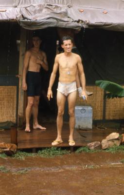Sgt Michael Cooper using the heavy rain for a shower. Phan Rang 1966 35th SPS