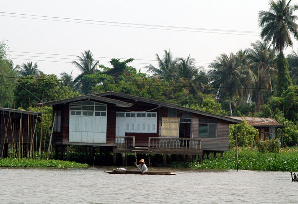 Man paddling a small canoe