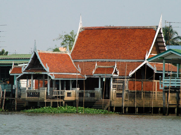 Red tiles house along the river