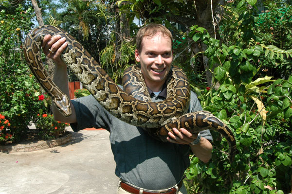 Roy and a python at Wat across from the Thonburi Snake Farm