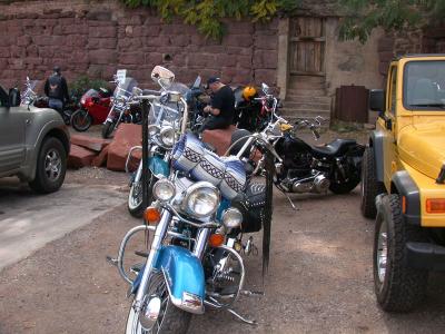 Ron fiddles with camera, surrounded by motorcycles