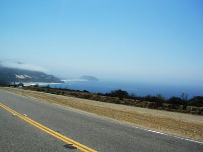 Shot of the Pacific coast South of Big Sur, taken backwards (over the shoulder) out of the left window while driving North on California State Route 1.
