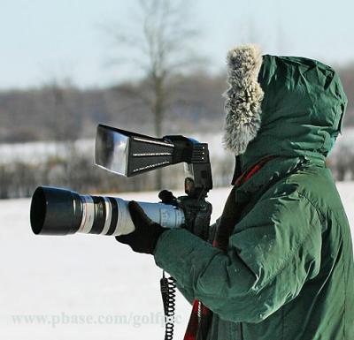 You can tell she is a serious bird photographer.   That is a Better Beamer flash extender on top of the camera.