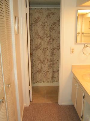 Divided bath upstairs has separate vanity w lots of light, mirrors,cabinets. Adjacent shower/tub, commode. Florida04 036.jpg
