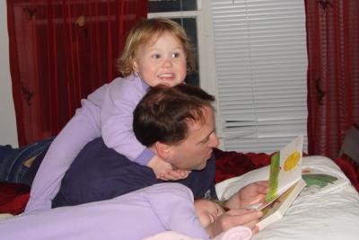 We love our bedtime books!  Rory is on top of Daddy and Reagan is reading along upside down