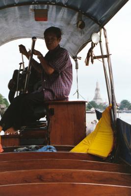 Boat ride on the Chao Phraya river with Wat Atun in the background, Bangkok