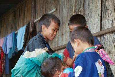 Hmong Children happily playing with the star stickers, Mae Hong Son Province