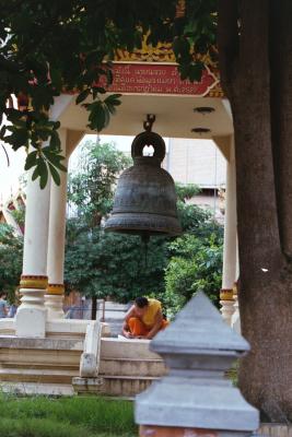 Monk studying under a prayer bell, Chiang Mai