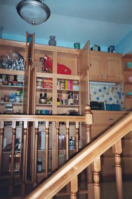 Open pantry storage, as seen from the window seats.