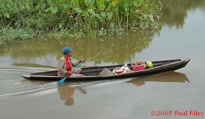 Lady selling fruit from a canoe - Palembang, Sumatra
