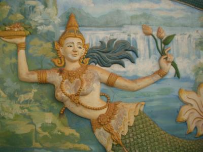 Topless mermaid with flowers and grapes. Buddhism?