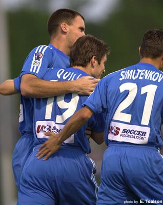 Quill celebrates his goal with teammates.