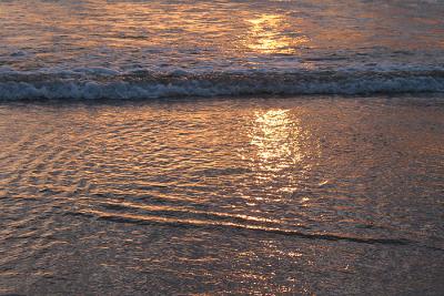 Sunset reflected in the waves