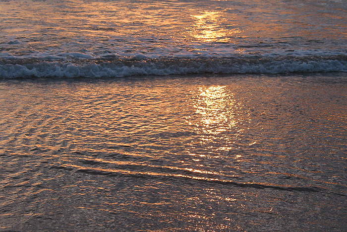 Sunset reflected in the waves
