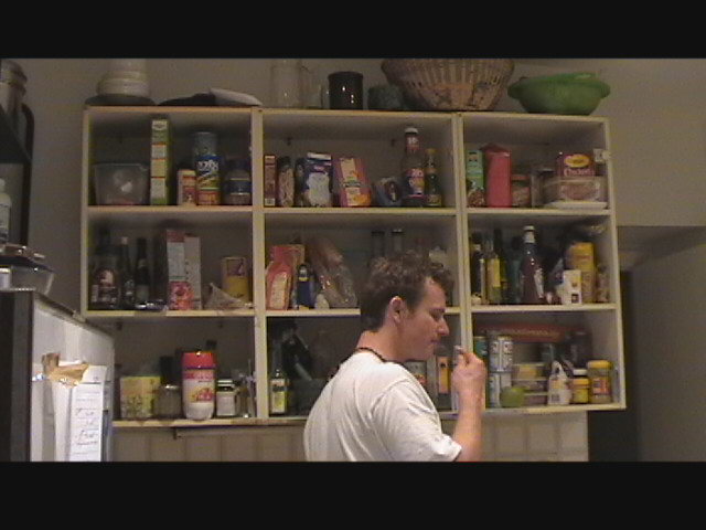 Paul getting caught eating in our flat kitchen.  Our shelves are the 3 on the right.  We need more room!!!!