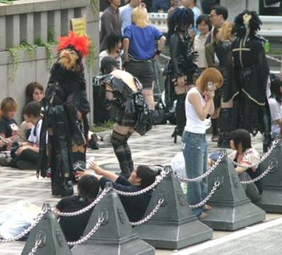 They all gathered around in a crowd across the street from the band that was playing.