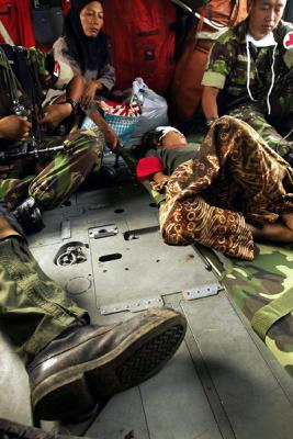 Indonesian woman tends to her pneumonia-ridden child