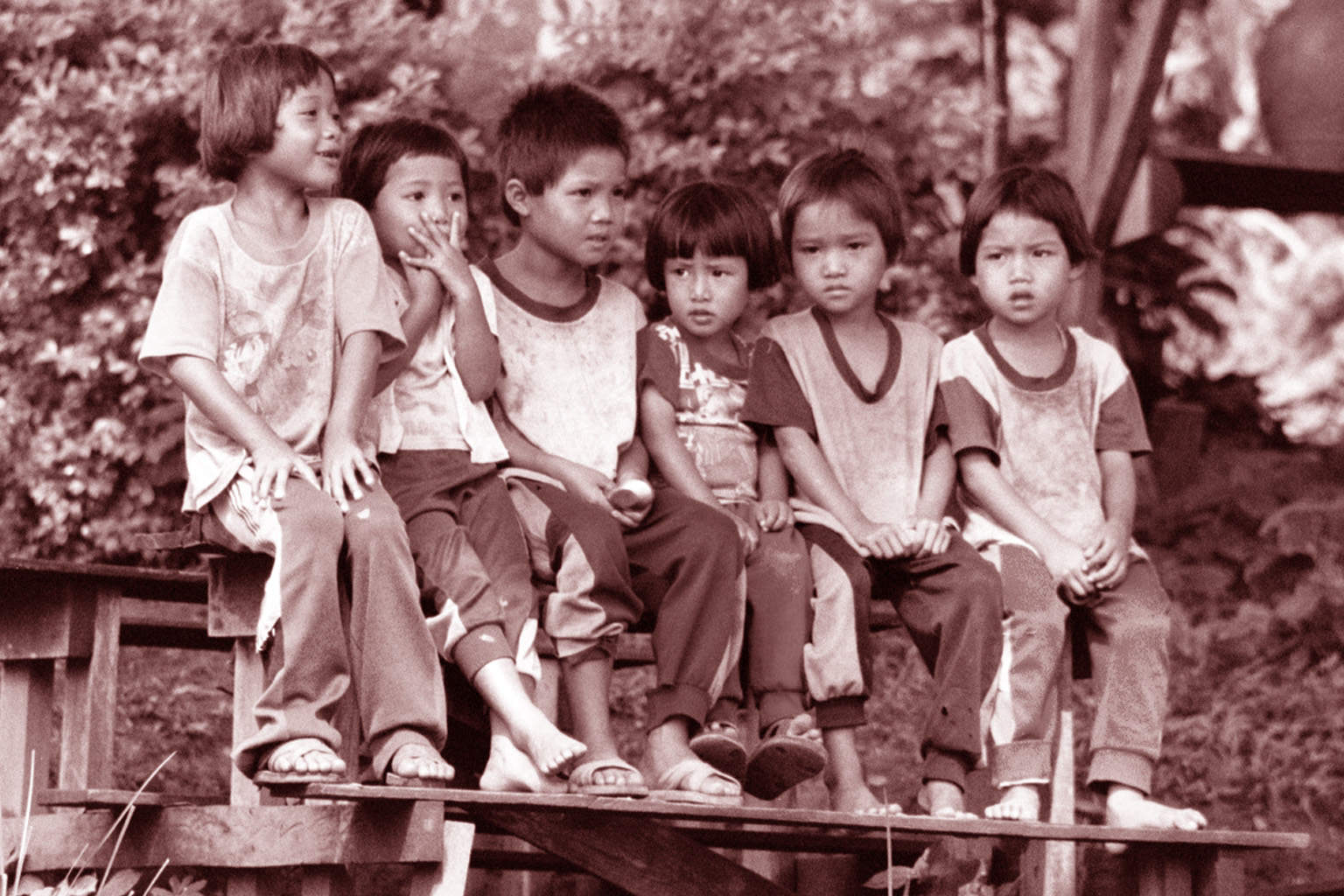 White Karen children sitting on a bench, Chiang Mai Province