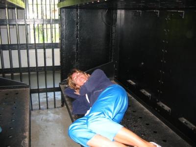 me laying on on of the jail cell beds, glad I didn't get bed bugs