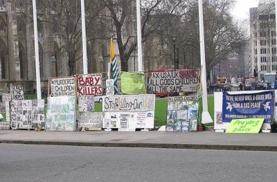 Protest signs across from Parliament