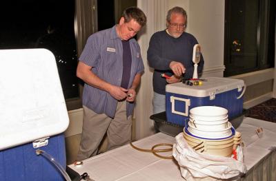 BURPers Steve Marler and Mel Thompson prepare taps for Friday night's reception featuring homebrewed Belgian style beers.