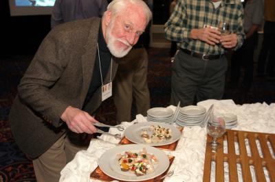 BURPer and MASHOUT host Chuck Pops Popenoe samples the eats at the reception.