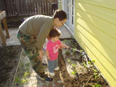 Mom and Leila planting strawberries