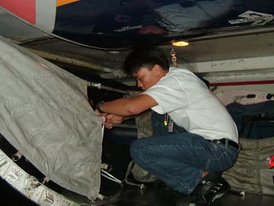 Putting up the cargo hold's webbing.