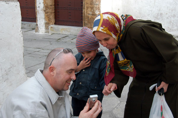 Robin showing some locals their photo