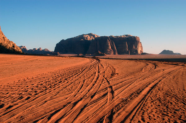 Tracks through the desert towards Khazali Mountain in Wadi Rum