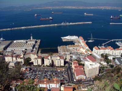 Gibraltar: looking E from the rock over the dockyards. Spanish town of Algericas in background