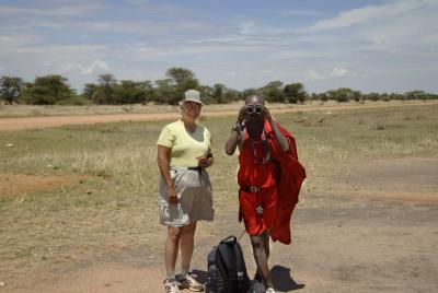 Marsha teaches a Masai to use binoculars.