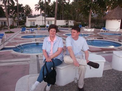 Mom and Sam by the hot tubs.Our rooms in the background.jpg